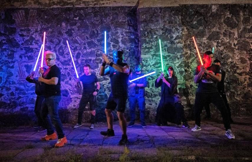 AFP | Miembros de la Academia de Caballeros Jedi (JKAMX) sostienen sables de luz durante una sesión de práctica grupal.