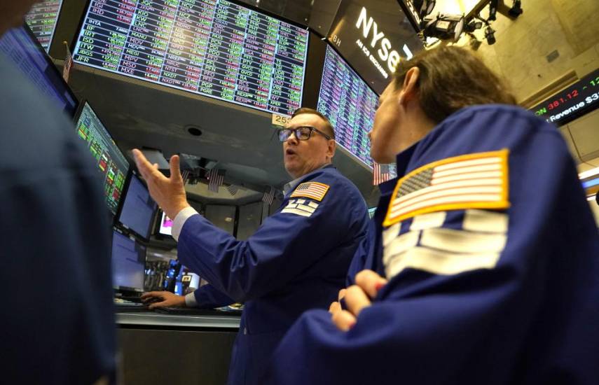 Traders work on the floor of the New York Stock Exchange (NYSE) at the opening bell on November 6, 2024, in New York City. - Wall Street stocks surged in opening trading on Wall Street Wednesday after US voters sent Donald Trump back to the White House and delivered him a Republican Senate. Major indices were up 1.8 percent or more in the early going as hopes about expected tax cuts and regulatory easing more than offset worries about higher tariffs. (Photo by TIMOTHY A. CLARY / AFP)